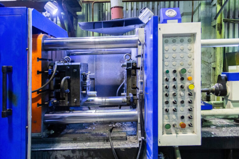 old horizontal die cast aluminium machine - opened, close-up with selective focus